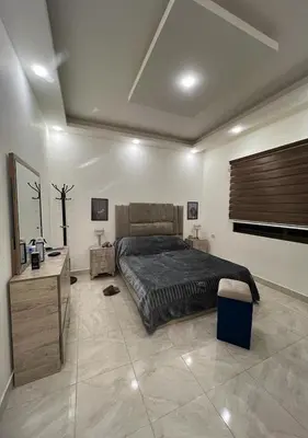 a bedroom with a bed and a dresser and a bed sidx sidx sidx sidx at Sweet Home In Amman - Family Friendly in Amman