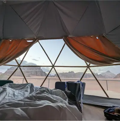 a room with a view of the desert from a tent at RUM CAMILLA lUXURY CAMP in Wadi Rum