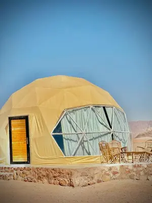 a large dome tent with chairs in the desert at RUM CAMILLA lUXURY CAMP in Wadi Rum