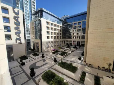 an aerial view of a courtyard in a city with buildings at DAMAC City View Penthouse in Amman