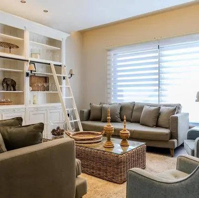 a living room with a couch and a table at Flamant Apartments in Amman