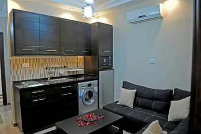 a living room with a couch and a washing machine at سامر برهم للاسكان in Amman