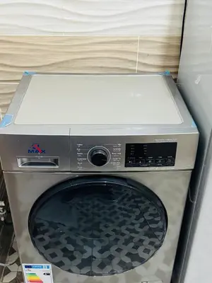 a microwave oven sitting on top of a washing machine at White Apartment in Aqaba