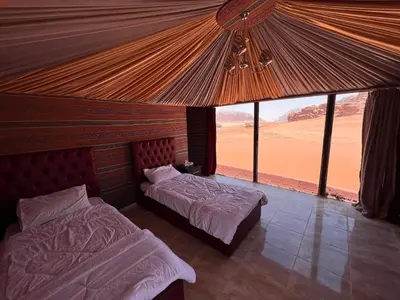 a bedroom with two beds and a view of the desert at Rum Experience in Aqaba