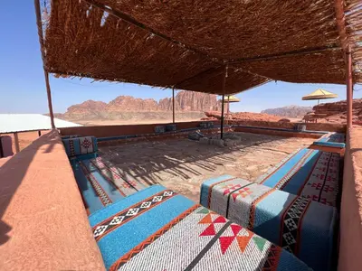 a view of the desert from a resort with tables and chairs at Rum Experience in Aqaba