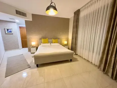 a bedroom with a bed with yellow pillows at High-end Apartment 2BDR in The most lively AMMAN شقة فاخرة في الدوار السابع in Amman