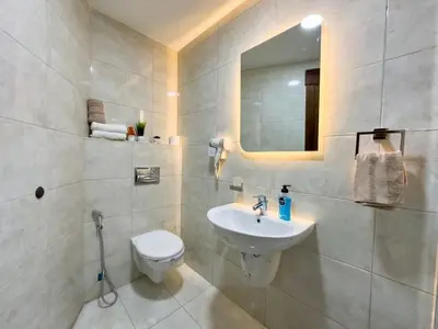 a bathroom with a sink and a toilet and a mirror at High-end Apartment 2BDR in The most lively AMMAN شقة فاخرة في الدوار السابع in Amman