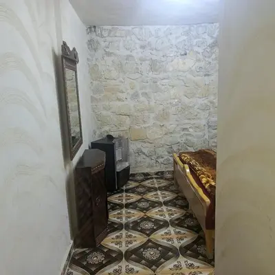 a room with a tv and a tiled floor at Dana Moon hostel in Dana