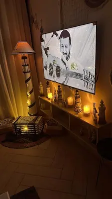 a room with a large screen with a lamp and candles at Azure haven Ayla Sea view Apartment in Aqaba