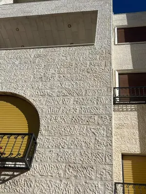 a brick building with a window and a balcony at Family Spacious newly furnished 2 Bedroom 2 bath in Amman