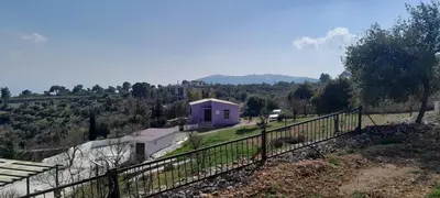 a purple house on a hill with a fence at Offgrid Jerash-Ajlune MountainView Studio Shalea شاليه استوديو جبال جرش in Jerash
