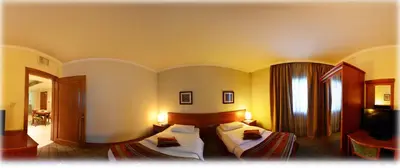 a hotel room with two beds and a television at فندق أميري سويت in Umm Uthainah