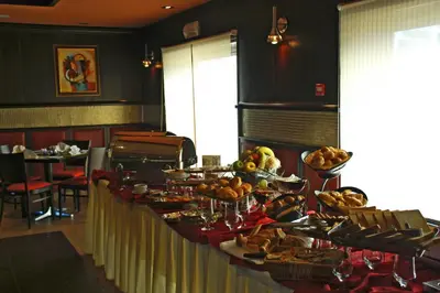 a buffet table with food on it in a restaurant at فندق أميري سويت in Umm Uthainah
