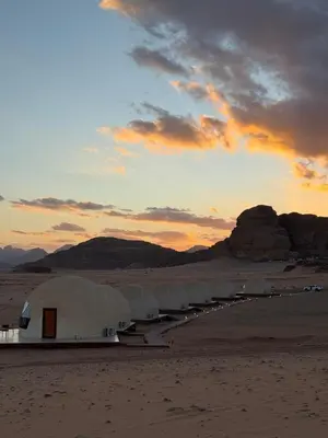 a row of domes in the desert at sunset at Wadi Rum famous luxury camp in Wadi Rum
