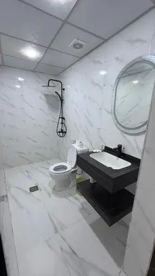 a white bathroom with a sink and a toilet at Wadi Rum famous luxury camp in Wadi Rum