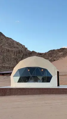 a domed building in the middle of a desert at Wadi Rum famous luxury camp in Wadi Rum