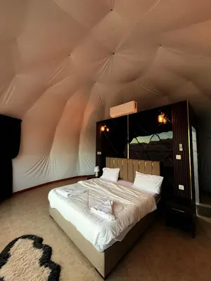 a bedroom with a large bed in a tent at Wadi Rum famous luxury camp in Wadi Rum