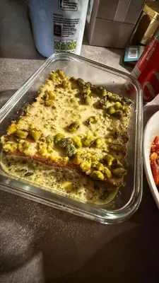a casserole dish of food with broccoli on a counter at Daban Inn in Dhībān