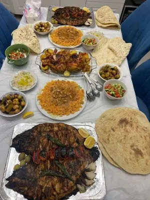 a table with many different types of food on it at Daban Inn in Dhībān