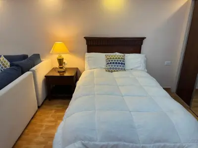 a bedroom with a large bed and a couch at Petra EcoStay in Wadi Musa