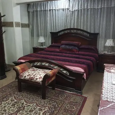 a bedroom with a large bed and a bench at Noplity bed and breakfast in Al Qunayţirah