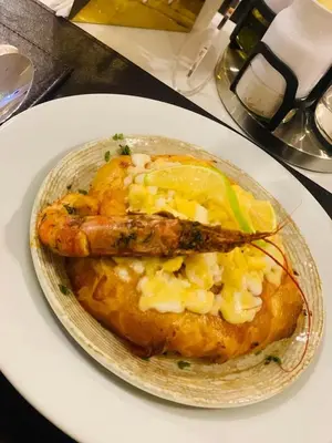 a plate of food with a fish on a table at Noplity bed and breakfast in Al Qunayţirah