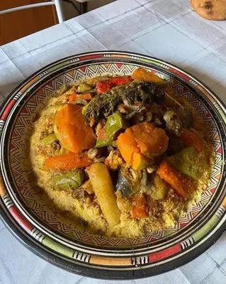 a plate of food with vegetables on a table at Noplity bed and breakfast in Al Qunayţirah