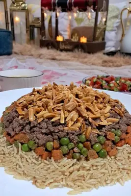 a plate of food with rice and nuts on it at Noplity bed and breakfast in Al Qunayţirah