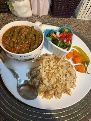 a plate of food with rice and a bowl of food at الطل هاوس in Ar Rashādīyah