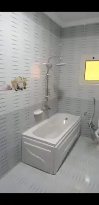 a white bathroom with a tub and a sink at الطل هاوس in Ar Rashādīyah