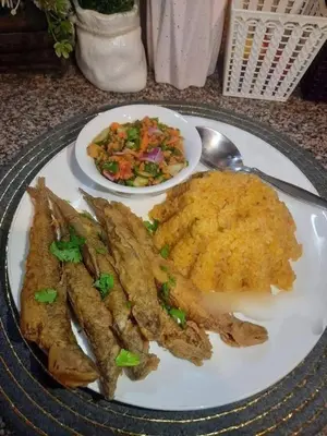 a plate of food with fried fish and a bowl of salad at الطل هاوس in Ar Rashādīyah