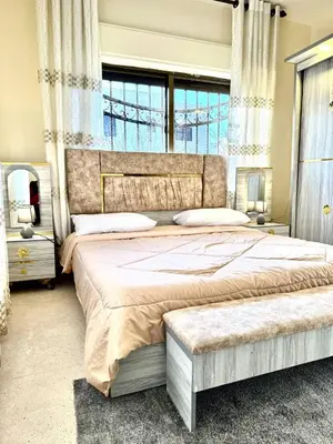a bedroom with a large bed and a large window at Stylish 3 Bedroom apartment in Amman in Amman
