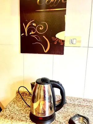 a black and silver tea kettle on a counter at Stylish 3 Bedroom apartment in Amman in Amman