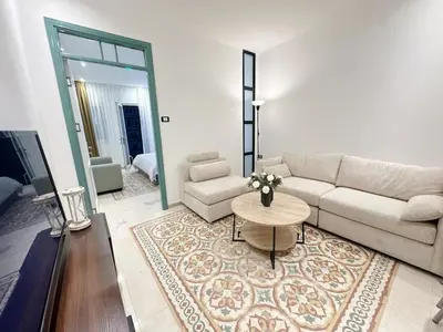 a living room with a couch and a table at Old Town Charming Two-Bedroom Flat in Amman