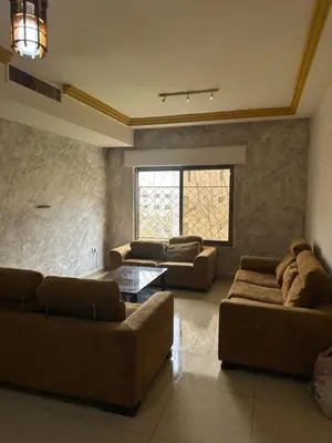 a living room with two couches and a table at شقه مفروشه in Amman