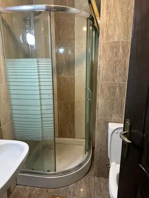 a bathroom with a shower and a sink and a toilet at شقه مفروشه in Amman