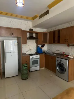 a kitchen with a white refrigerator and a dishwasher at شقه مفروشه in Amman