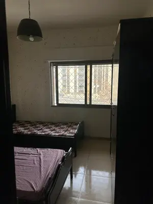 a room with two beds and a window at شقه مفروشه in Amman