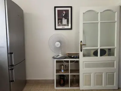 a white door in a kitchen with a fan at 2 Bedroom apt in Jabal Weibdeh with Balcony in Amman