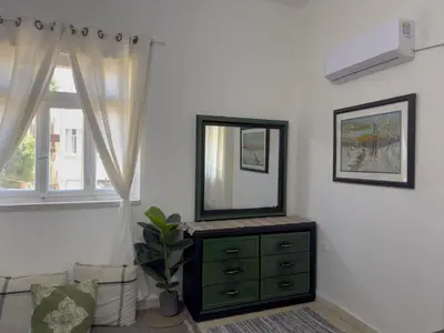 a mirror on a dresser in a room with a window at 2 Bedroom apt in Jabal Weibdeh with Balcony in Amman