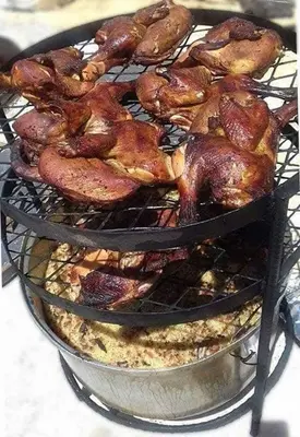 a grill with chickens and other food on it at اذرح فارم in Udhruḩ