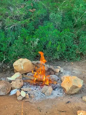 a fire pit with some rocks and rocks at اذرح فارم in Udhruḩ