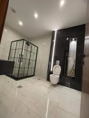 a bathroom with a toilet and a mirror at ساكب هاوس in Sākib
