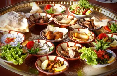 a tray of different types of food on a table at Kareem celebrations Hall صاله افراح in Irbid