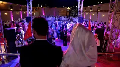 a woman standing in front of a crowd of people at Kareem celebrations Hall صاله افراح in Irbid