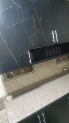 an overhead view of a kitchen with black cabinets at الجفر موتل in Al Jafr
