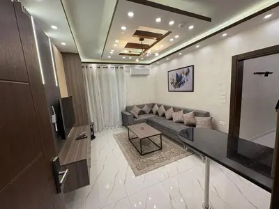 a living room with a couch and a table at Third circle Luxury Hotel apartment New in Amman