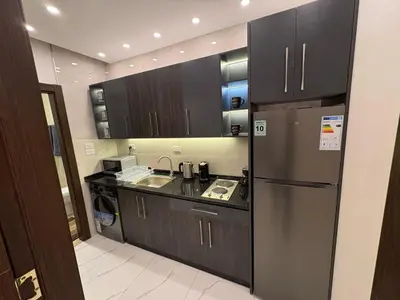 a kitchen with a stainless steel refrigerator and a sink at Third circle Luxury Hotel apartment New in Amman