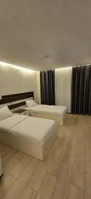 a hotel room with two beds in a room at Balcony Hotel in Amman