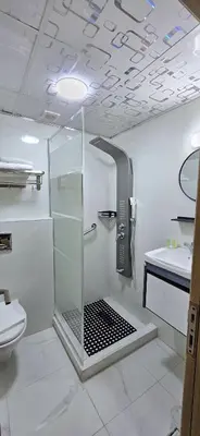 a bathroom with a shower and a toilet and a sink at Balcony Hotel in Amman